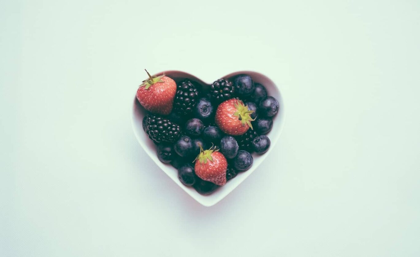 Healthy fruits are placed in a heart shaped bowl